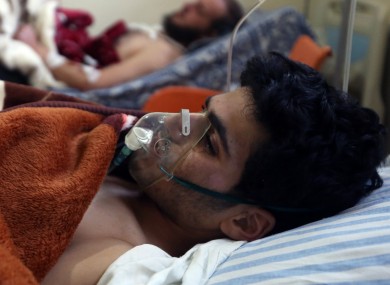 Mohsin Awad (20) who was wounded in Yabroud as a result of Syrian government shelling, rest in a field hospital at the Lebanese-Syrian border town of Arsal, in eastern Lebanon