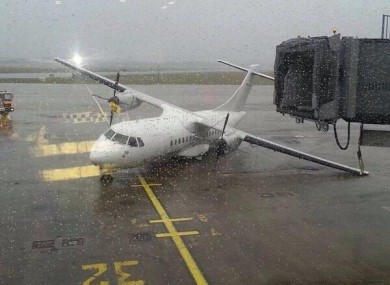 A stationary plane knocked over amid the high winds.
