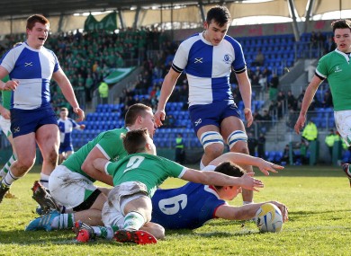 Andrews' Ryan Bradley scores his side's first try despite attention from Nick Peters and Paul Ryan of Gonzaga.