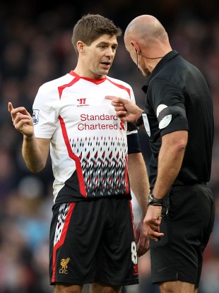 Match referee Howard Webb speaks to Reds skipper Steven Gerrard.