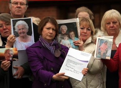 Relatives of patients involved in the Francis report hold pictures of their loved ones outside the Moat House hotel near Stafford, after Robert Francis QC delivered his report into failings at Stafford Hospital.