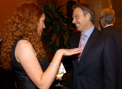 British Prime Minister, Tony Blair speaks to Rebekah Brooks, then Sun editor in 2004.
