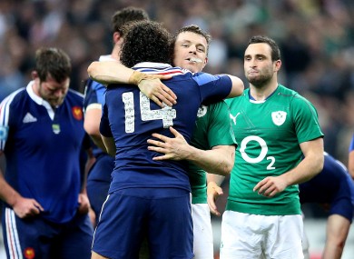 Yoann Huget hugs Brian O'Driscoll after France's 22-20 loss to Ireland.
