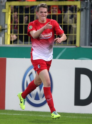Freiburg's Matthias Ginter celebrates scoring in a German Cup game.