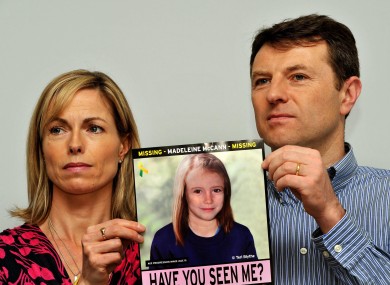 Madeleine McCann's parents Gerry and Kate hold a poster of their daughter.