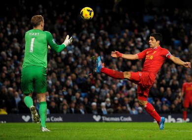 Joe Hart collects the ball under pressure from Luis Suarez.