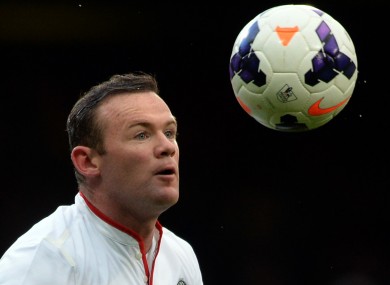 Manchester United's Wayne Rooney eyes the ball before scoring.