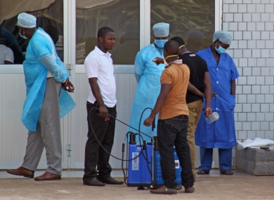 Medical staff at the emergency entrance of a hospital receive suspected Ebola patients in Guinea earlier today.