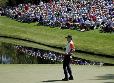 Rory McIlroy watches his putt on the 16th green during the first round of the Masters golf tournament yesterday.