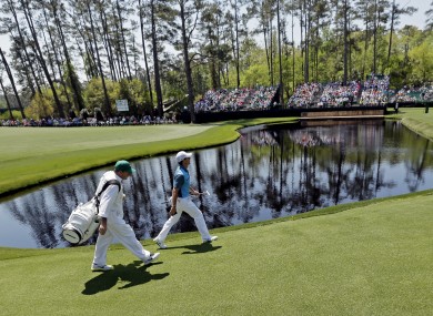 McIlroy walks with his caddie Jean-Paul Firtzgerald along the 15th fairway.