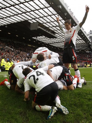 Liverpool triumphantly celebrate Luis Suarez' goal at Old Trafford.