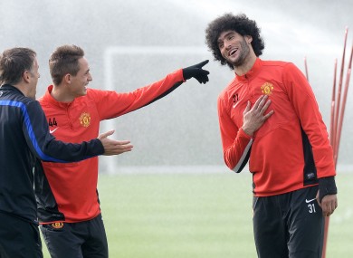Manchester United's Marouane Fellaini shares a joke with Adnan Januzaj (centre) and Phil Neville at training yesterday.