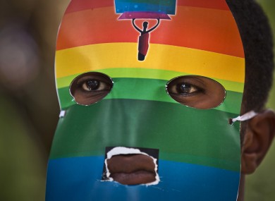 A Kenyan man wears a mask to preserve his anonymity as they stage a rare protest against Ugandan's laws on sexuality.