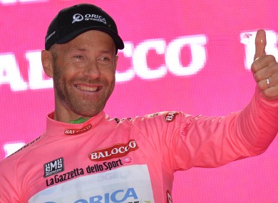 Canadian Svein Tuft sprays sparkling wine on podium after taking the pink jersey of leader of the race during the first stage of the Giro d'Italia, Tour of Italy cycling race, in Belfast, Northern Ireland.