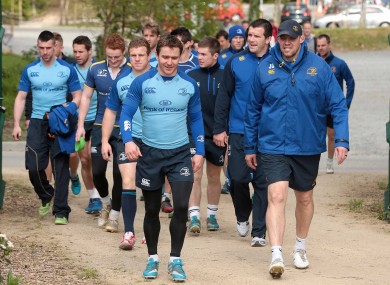 Eoin Reddan and coach Jono Gibbes lead the squad out for training.