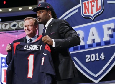 South Carolina defensive end Jadeveon Clowney holds up the jersey for the Houston Texans beside NFL's Roger Goddell.