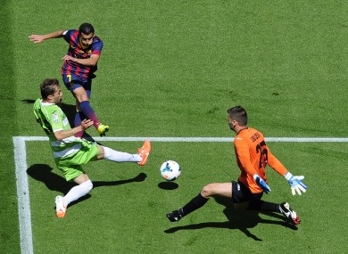 Barcelona's Pedro has a shot saved by Getafe goalkeeper Julio Cesar.