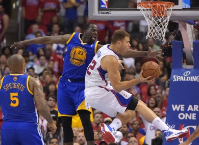 Clippers forward Blake Griffin, right, puts up a shot as Golden State Warriors forward Draymond Green defends.