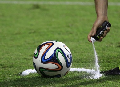 A referee practises using vanishing spray during a training session.