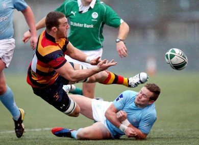Butterworth offloads during an Ulster Bank League clash with Garryowen.