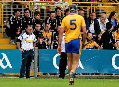 Davy Fitzgerald looks on as Brendan Bugler leaves the field after being sent off.