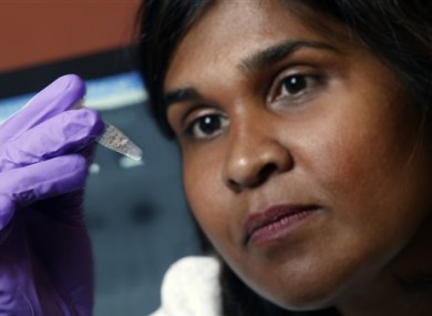In this undated file image provided by Johns Hopkins Medicine in 2005 Dr. Deborah Persaud, a pediatric HIV expert at Johns Hopkins' Children's Center in Baltimore, holds a vial.