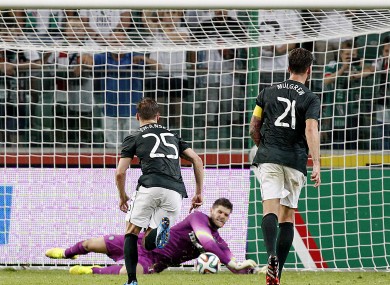 Fraser Forster saves a penalty in Warsaw last night.