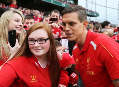 Liverpool's Daniel Agger poses for a photo with a supporter at half time at the Aviva Stadium in May.