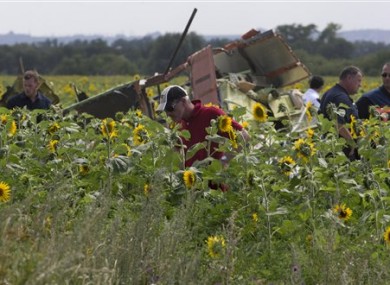 Dutch and Australian investigators examine pieces of the crashed Malaysia Airlines Flight 17 in the village of Rassipne, Donetsk region, eastern Ukraine today.