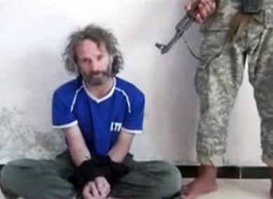 In this image made from undated video obtained by The Associated Press, which has been authenticated based on its contents and other AP reporting, a man believed to be Peter Theo Curtis, a U.S. citizen held hostage by an al-Qaida linked group in Syria, delivers a statement.