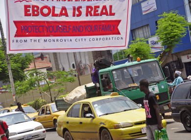 A banner reading 'Ebola is real, Protect yourself and your family', warns people of the Ebola virus in Monrovia, Liberia.