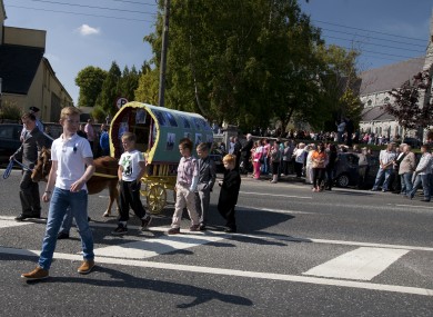 A minature pony and traditional Traveller caravan leads out the coffins of coffins of 9 year old twin brothers, Tom and Paddy O'Driscoll, after the funeral mass in the Holy Cross Church in Charleville, County Cork.