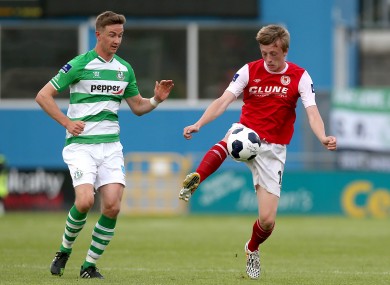Chris Forrester of St Patrick's Athletic in possession with Shamrock Rovers midfielder Ronan Finn.
