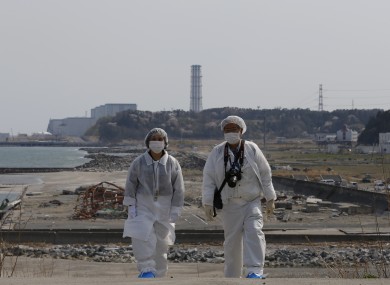 Two people tour the site of the Fukushima nuclear disaster in Japan.