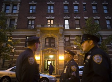 Police officers stand outside the home of Craig Spencer.
