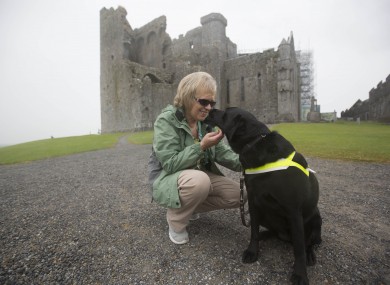 Olive Cummins with her dog Eve at the Rock of Cashel.