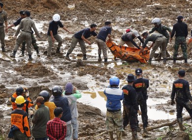 Rescuers move body found in the mud