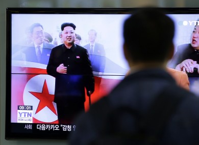 A man watches a TV news program showing North Korean leader Kim Jong Un.