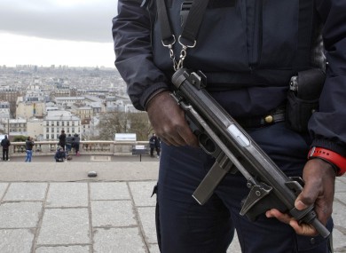 A French police officer patrols around the Sacre Coeur basilica in the Paris Montmartre district.