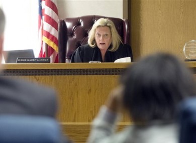 Lake County Juvenile Court Judge Karen Lawson, back, tells the 11-year-old girl her rights.