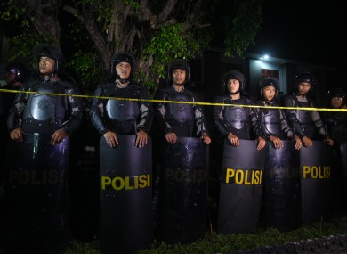 Indonesian police line up in front of a prison during the transfer of Australian death row prisoners, Andrew Chan and Myuran Sukumaran in Bali.