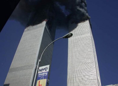 Plumes of smoke pour from the World Trade Center towers in New York Tuesday, Sept. 11, 2001.