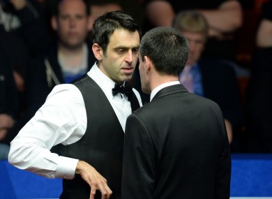 Ronnie O'Sullivan is spoken to by referee Olivier Marteel in his second round match against Matthew Stevens.