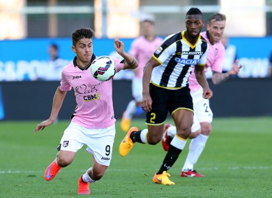 Palermo's Paulo Dybala, left, controls the ball past Udinese's Molla Wague.