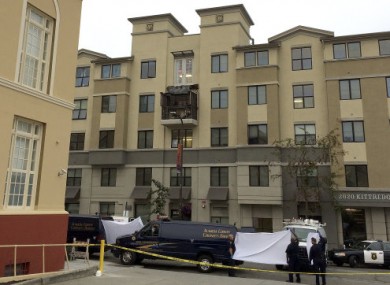 Police and officials stand outside of the Library Gardens apartment complex.