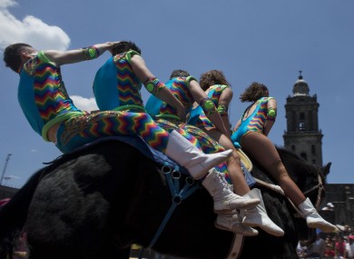 Circus performers ride five to a horse during a free public show to protest Mexico City's ban on circus animals last summer.