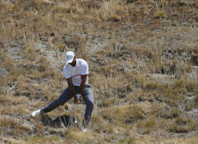 Tiger Woods hits out of the tall fescue grass on the eighth hole during the second round of the US Open.