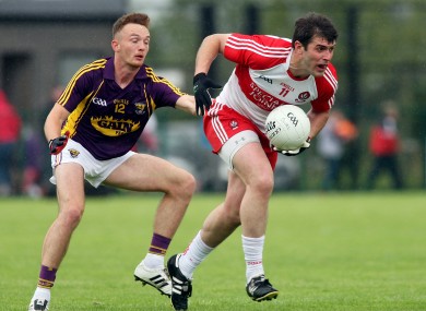 Mark Lynch and Kieran Butler contest possession.