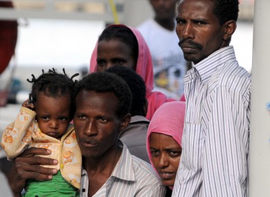 Migrants wait to be disembarked from the Swedish fire fiighting vessel in southern Italy earlier this week.
