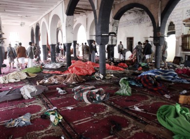Bodies of people killed in a suicide attack during the noon prayer are covered in blankets in a mosque in Sanaa